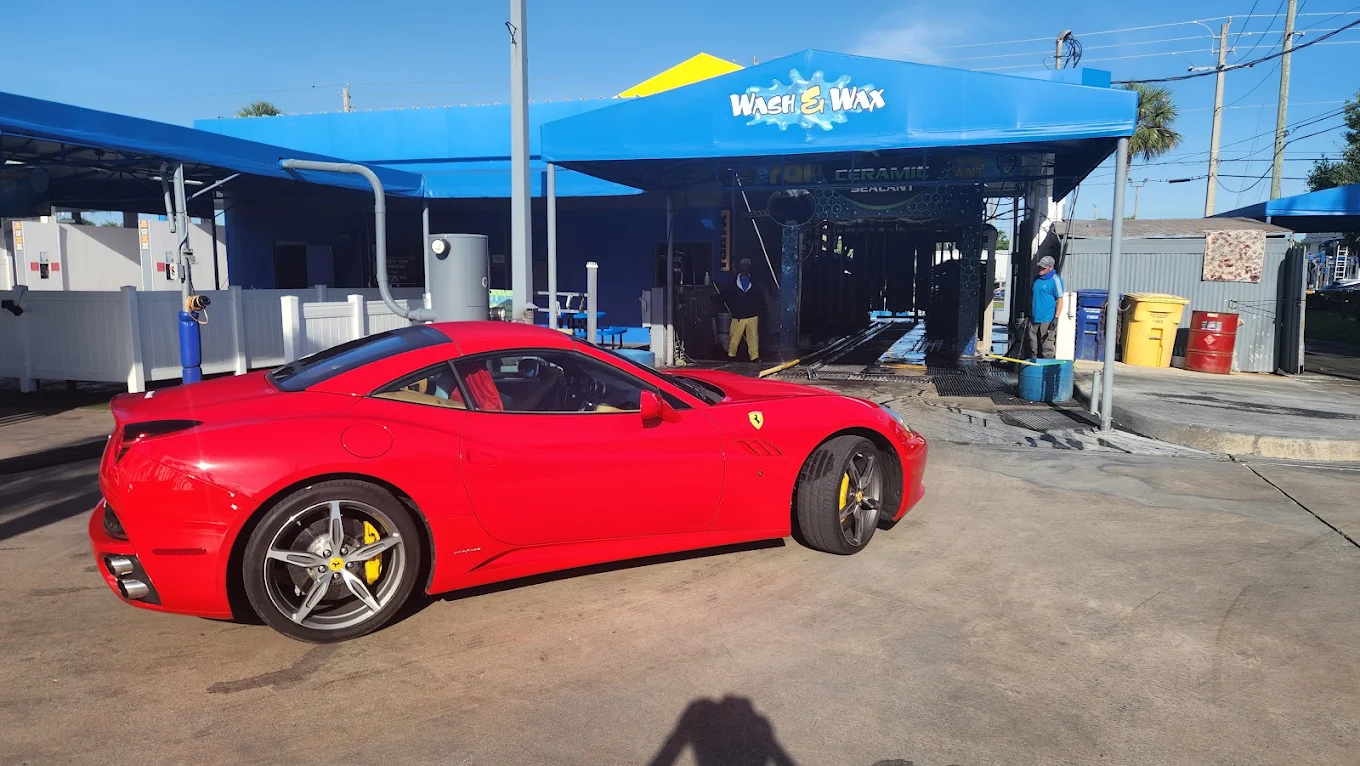 A gleaming red sports car fresh from the wash at Palm Beach Auto Spa